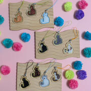 A photo of 10 phone charms featuring illustrations of various short haired cat colors and patterns, illustrated by Ayumutan Art