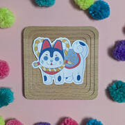 A picture of a sticker with an illustration of an Inu hariko doll